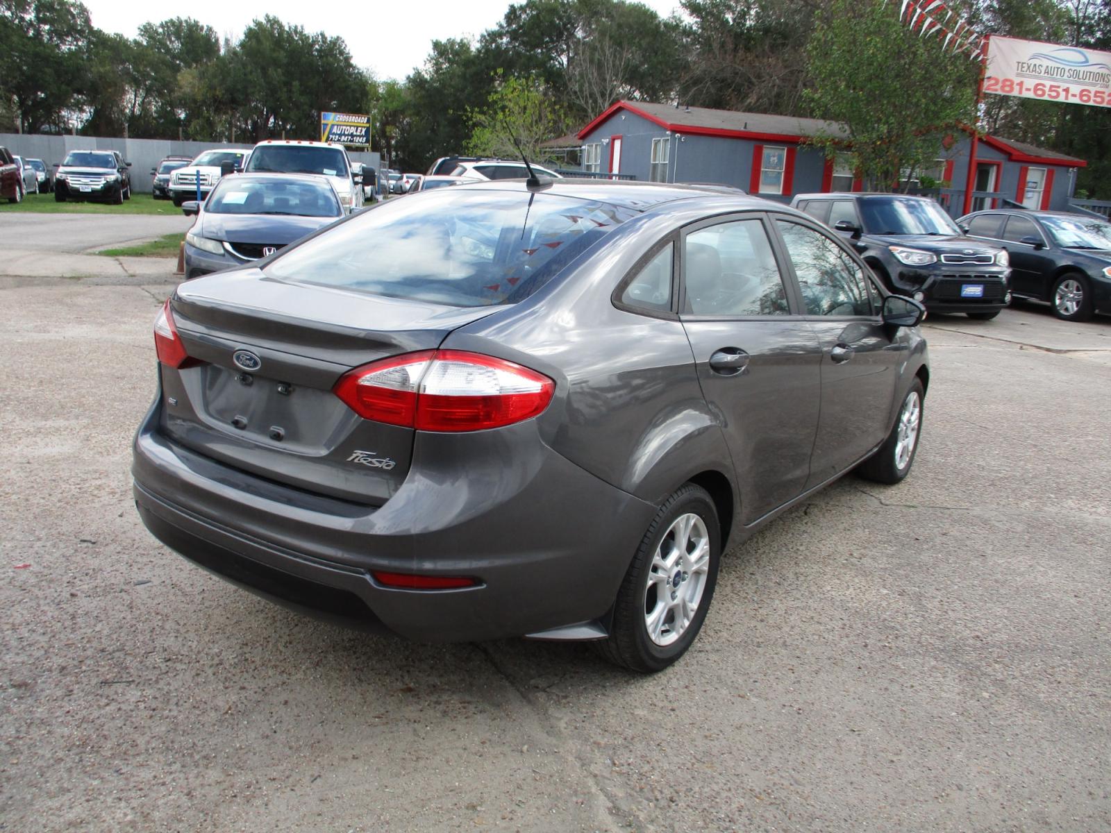 2015 GRAY FORD FIESTA SE Sedan (3FADP4BJ5FM) with an 1.6L L4 DOHC 16V engine, 5-SPEED MANUAL OR 6-SPEED AUTOMATIC transmission, located at 19224 Kuykendahl Rd, Spring, TX, 77379, (713) 947-1245, 30.049259, -95.491402 - It's like a brand new car. You won't believe how tight it drives. Aero-crisp. Sure-footed. Smart. Inspired. This unit has it all, including the admiration of some of the toughest critics in the world. In a single year, Focus was named “Best Car to Buy 2012” by TheCarConnection.com, “One of the - Photo #2