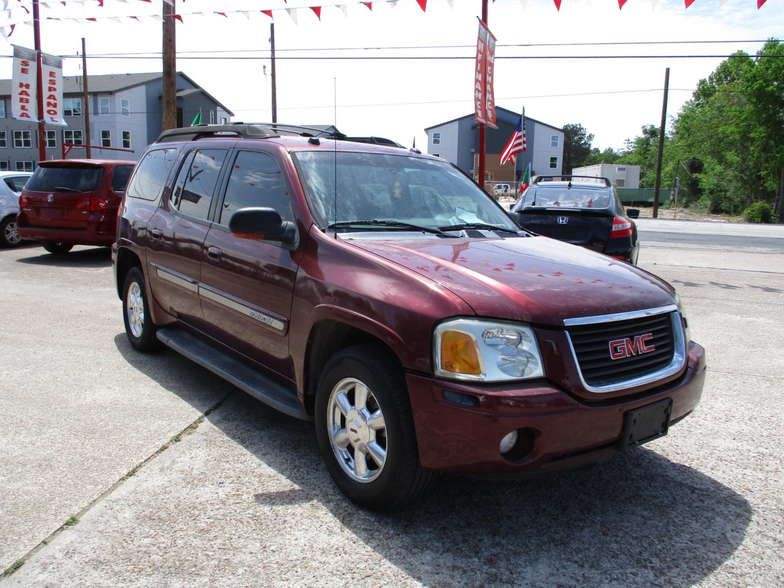 2005 RED GMC ENVOY XL SLE 4WD (1GKET16S456) with an 4.2L L6 DOHC 24V engine, 4-SPEED AUTOMATIC transmission, located at 19224 Kuykendahl Rd, Spring, TX, 77379, (713) 947-1245, 30.049259, -95.491402 - This unit has all the strength, power, and security you will ever need in a SUV. The power is a uncompromising Vortec 4200 six-cylinder engine that produces enough horsepower to make this trail blazer one of the most powerful SUV's on the market. It's exemplified in the strength with full-length hyd - Photo #0