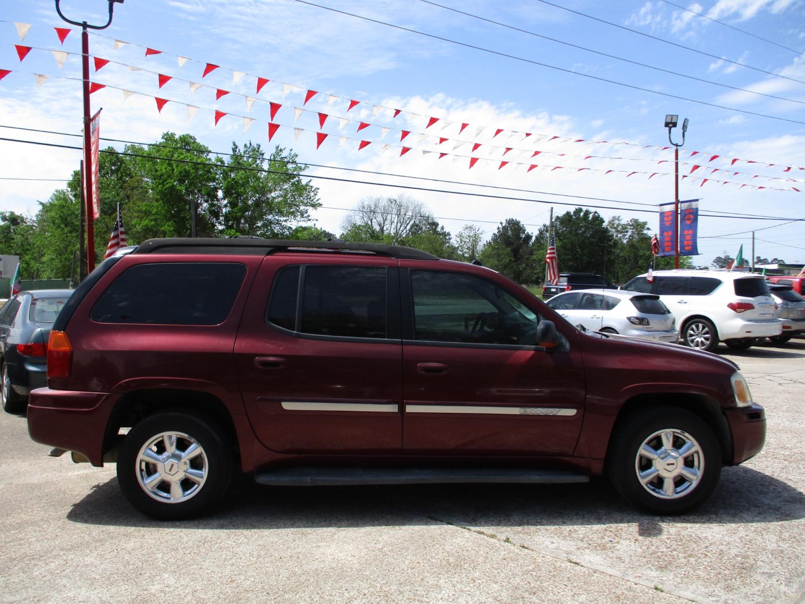 2005 RED GMC ENVOY XL SLE 4WD (1GKET16S456) with an 4.2L L6 DOHC 24V engine, 4-SPEED AUTOMATIC transmission, located at 19224 Kuykendahl Rd, Spring, TX, 77379, (713) 947-1245, 30.049259, -95.491402 - This unit has all the strength, power, and security you will ever need in a SUV. The power is a uncompromising Vortec 4200 six-cylinder engine that produces enough horsepower to make this trail blazer one of the most powerful SUV's on the market. It's exemplified in the strength with full-length hyd - Photo #1