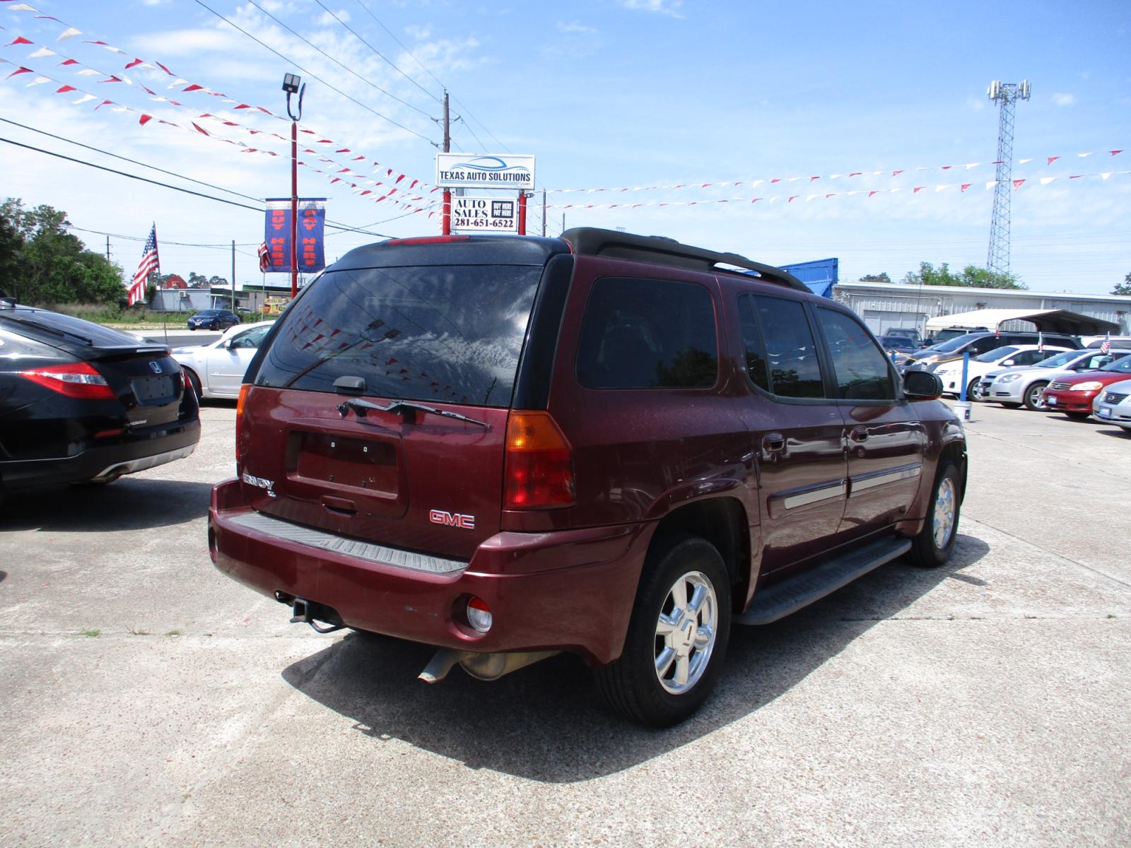 2005 RED GMC ENVOY XL SLE 4WD (1GKET16S456) with an 4.2L L6 DOHC 24V engine, 4-SPEED AUTOMATIC transmission, located at 19224 Kuykendahl Rd, Spring, TX, 77379, (713) 947-1245, 30.049259, -95.491402 - This unit has all the strength, power, and security you will ever need in a SUV. The power is a uncompromising Vortec 4200 six-cylinder engine that produces enough horsepower to make this trail blazer one of the most powerful SUV's on the market. It's exemplified in the strength with full-length hyd - Photo #2
