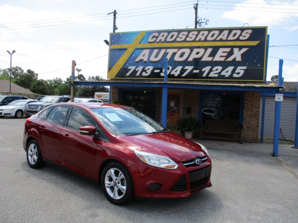 2013 MAROON FORD FOCUS SE Sedan (1FADP3F23DL) with an 2.0L L4 DOHC 16V engine, 5-SPEED MANUAL OR 6-SPEED AUTOMATIC transmission, located at 310 Spencer Hwy, South Houston, TX, 77587, (713) 947-1245, 29.664383, -95.228897 - It's like a brand new car. You won't believe how tight it drives. Aero-crisp. Sure-footed. Smart. Inspired. This unit has it all, including the admiration of some of the toughest critics in the world. In a single year, Focus was named “Best Car to Buy 2012” by TheCarConnection.com, “One of the - Photo #0