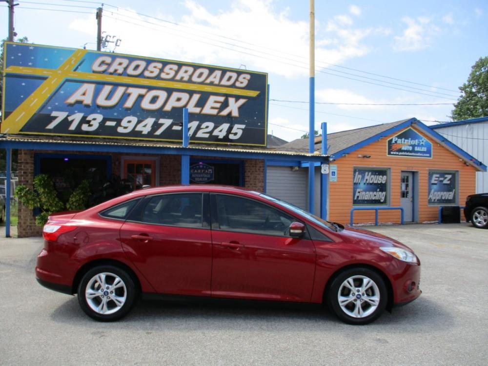 2013 MAROON FORD FOCUS SE Sedan (1FADP3F23DL) with an 2.0L L4 DOHC 16V engine, 5-SPEED MANUAL OR 6-SPEED AUTOMATIC transmission, located at 310 Spencer Hwy, South Houston, TX, 77587, (713) 947-1245, 29.664383, -95.228897 - It's like a brand new car. You won't believe how tight it drives. Aero-crisp. Sure-footed. Smart. Inspired. This unit has it all, including the admiration of some of the toughest critics in the world. In a single year, Focus was named “Best Car to Buy 2012” by TheCarConnection.com, “One of the - Photo #1
